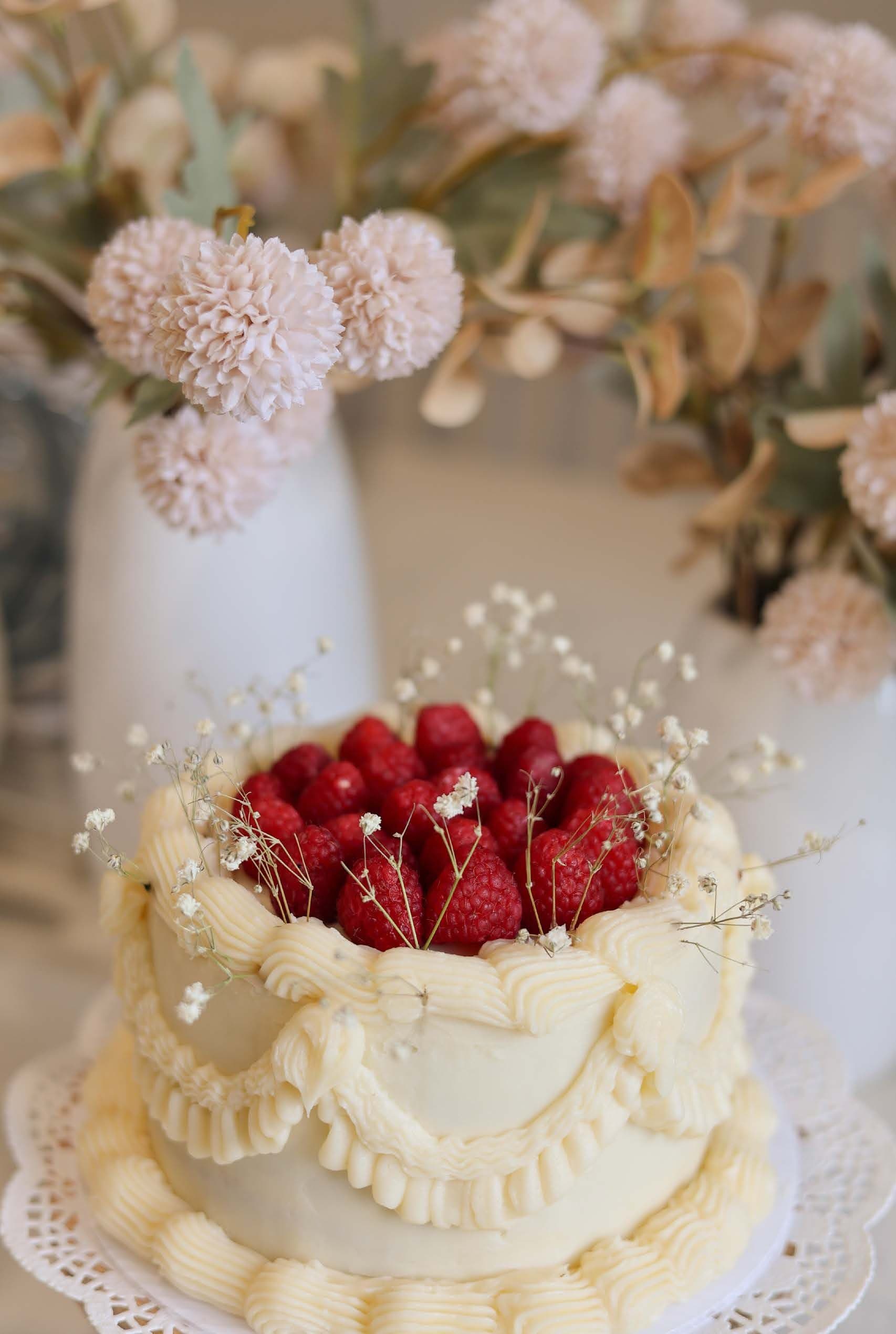 Raspberry vintage buttercream cake topped with fresh raspberries